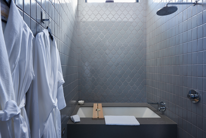 Hand laid Fire Clay tile add warmth to this spa like guest bath.